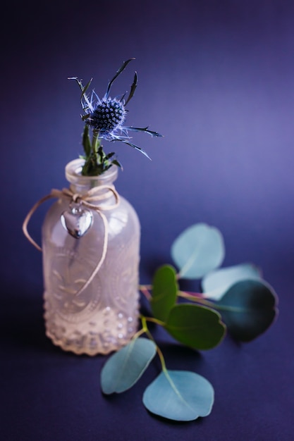 Little decorative corn stands in a glass bottle