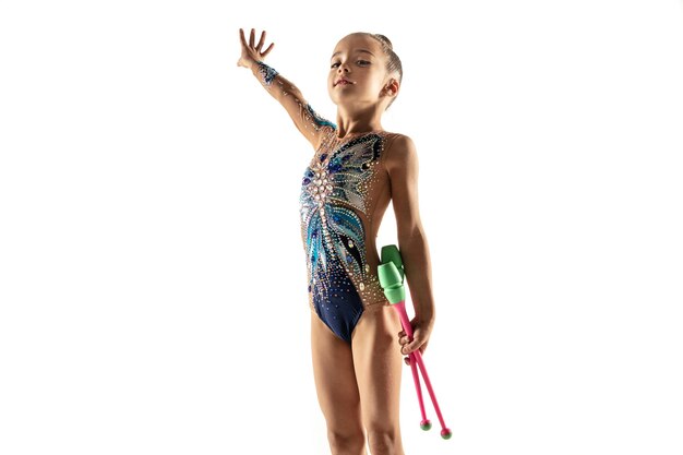 Little flexible female gymnast isolated on white wall