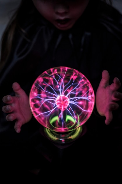 Free Photo little fortune teller with a plasma ball