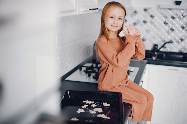 Free photo little girl cook the dough for cookies