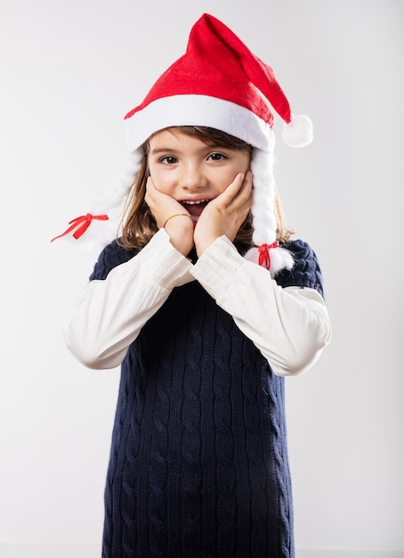 Free photo little girl covering her mouth with both hands