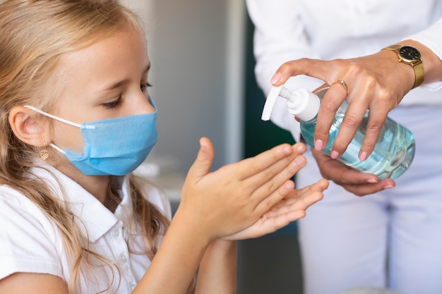 Little girl disinfecting her hands