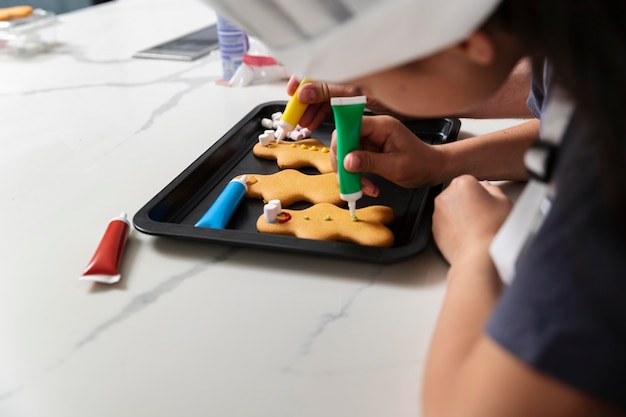 Little girl doing gingerbread cookies