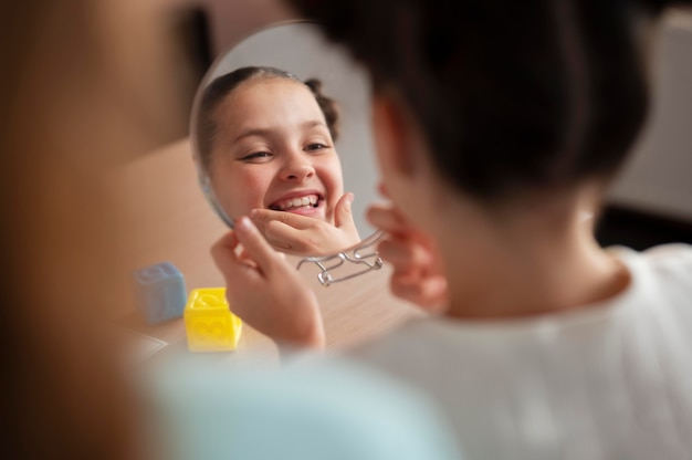 Free photo little girl doing speech therapy at a clinic