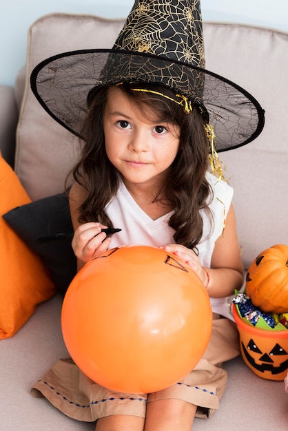 Little girl drawing a halloween baloon