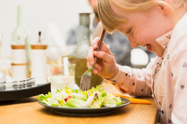 Little girl eating tasty dish