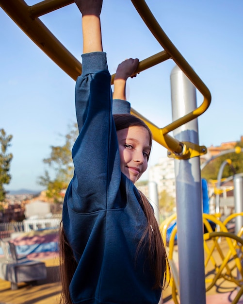 Free photo little girl having fun at the playground outside