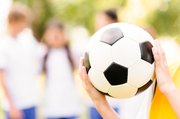 Little girl holding a football close-up