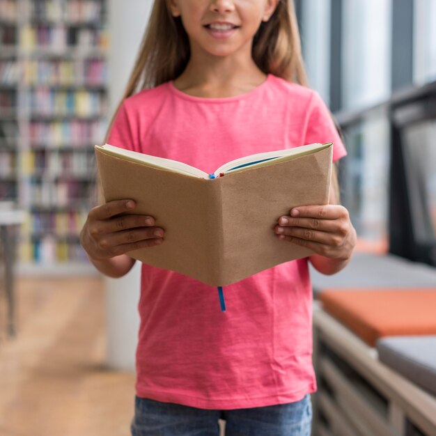 Little girl holding an opened book