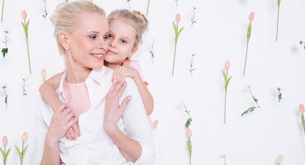 Little girl hugging beautiful mother