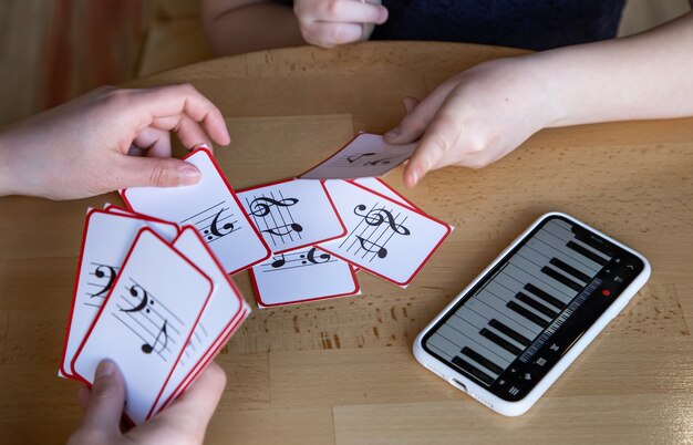 A little girl learns notes in a playful way, with the help of special musical cards