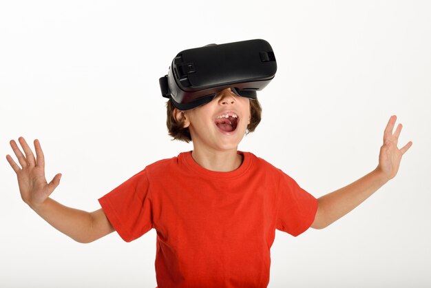 Little girl looking in VR glasses and gesturing with his hands.