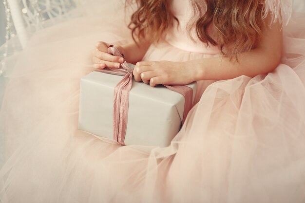 Free Photo little girl near christmas tree in a pink dress