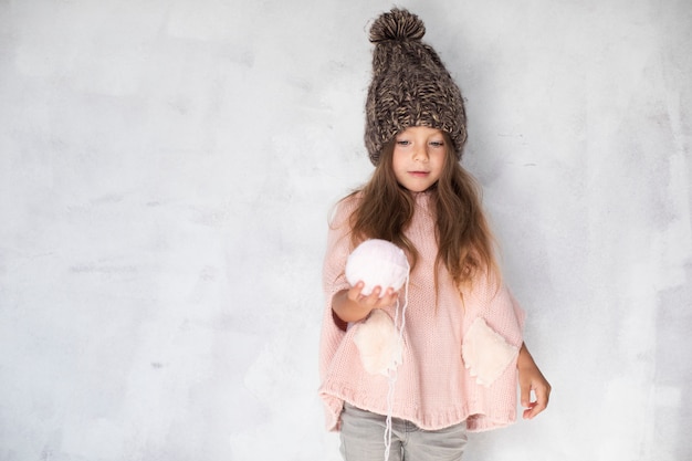 Free photo little girl offering a snowball