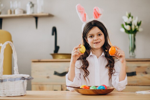 Little girl painting eggs for easter