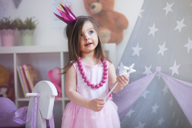 Free photo little girl playing at her room