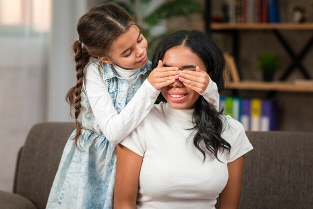 Little girl playing with her mom