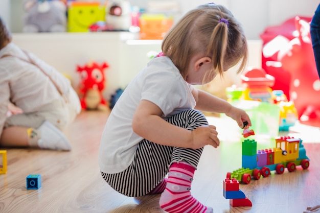 Little girl playing with train toy