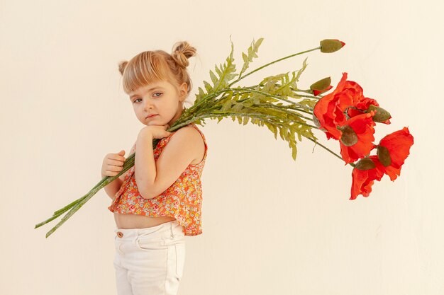 Little girl posing with flowers