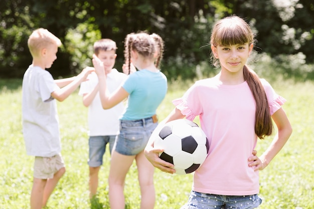 Little girl posing with football ball