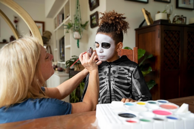 Free Photo little girl preparing for halloween with a skeleton costume