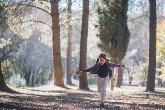 Free Photo little girl running in forest