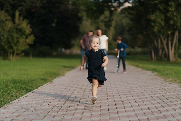 Little girl running while her family following her