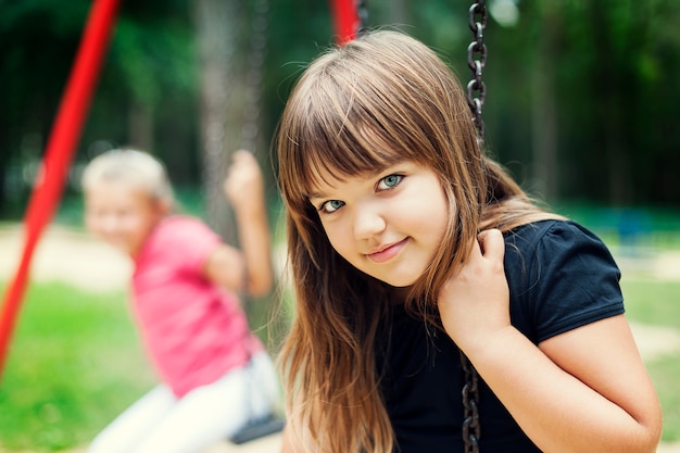 Little girl smiling on swing