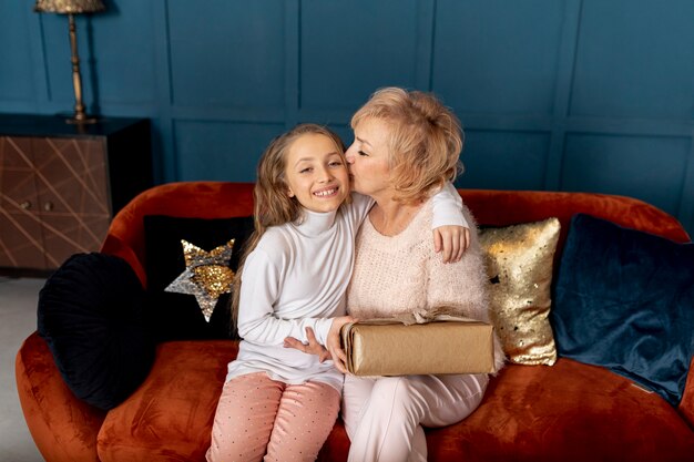 Little girl spending time with her grandmother at home