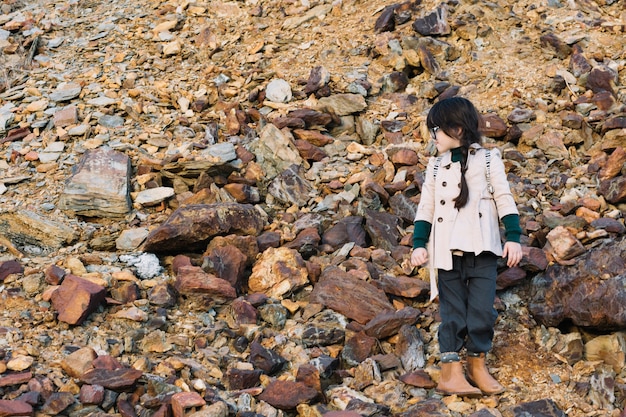 Free Photo little girl standing on hill