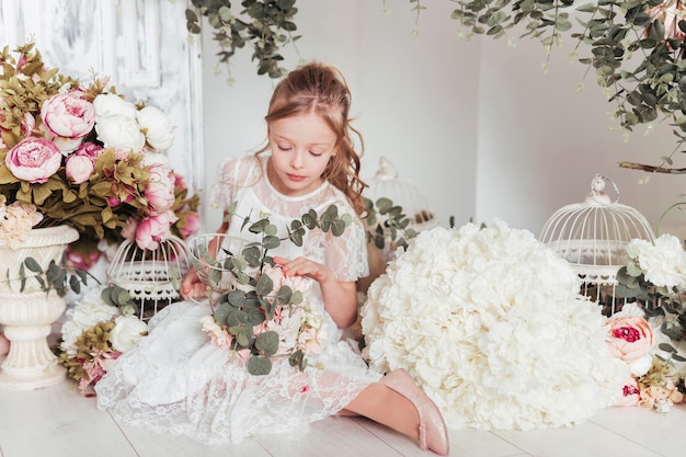 Little girl surrounded by flowers