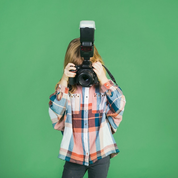 Free photo little girl taking picture with camera