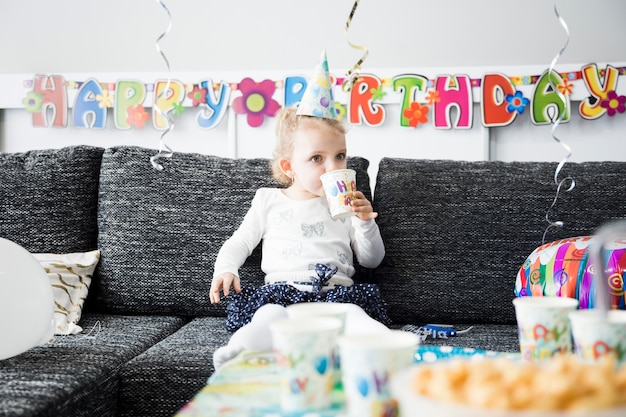 Free photo little girl tasting party drink