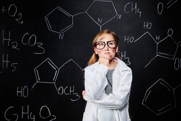 Little girl thinking about new chemical bond