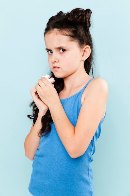 Little girl trying to hide the snack