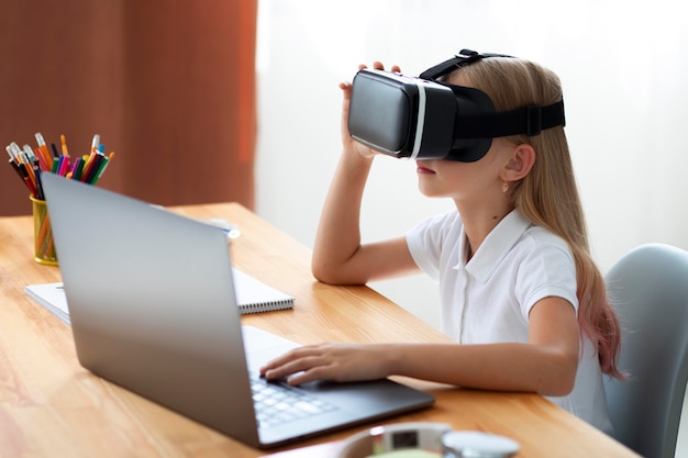 Free Photo little girl using virtual reality goggles