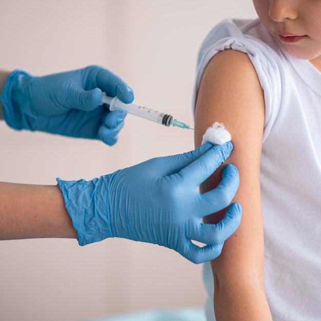 Free photo little girl vaccinating for coronavirus at the hospital