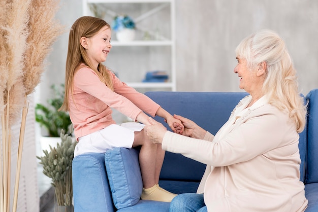 Little girl with grandma sitting on couch