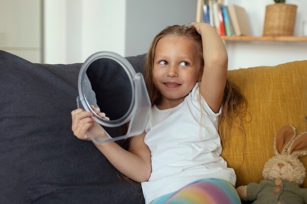 Little girl with head lices taking care of her hair