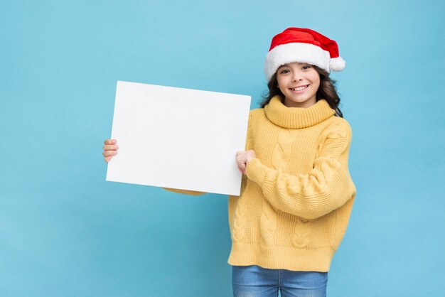 Little girl with poster mockup in hands