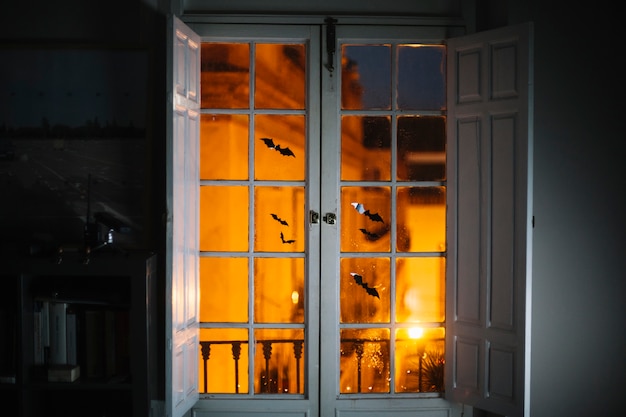 Little Halloween paper bats on window in room