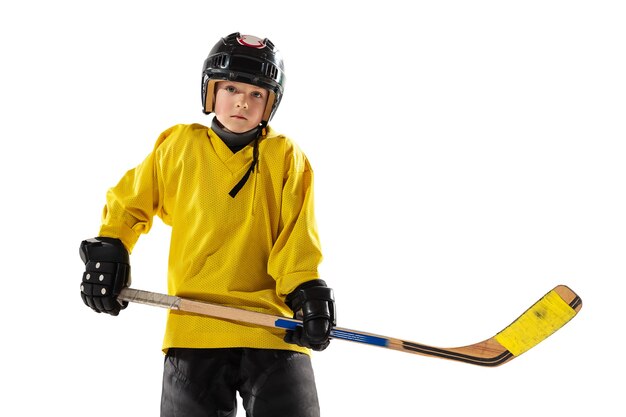 Little hockey player with the stick on ice court