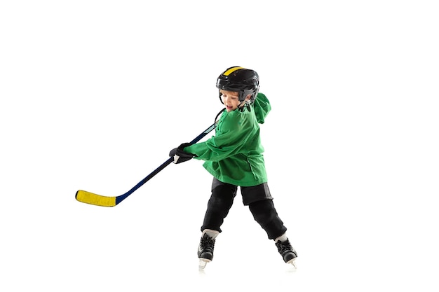 Little hockey player with the stick on ice court