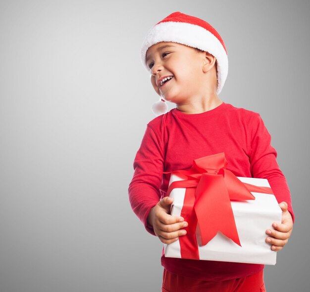 Little kid holding a white gift