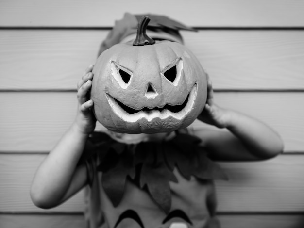 Free photo little kid with halloween pumpkin