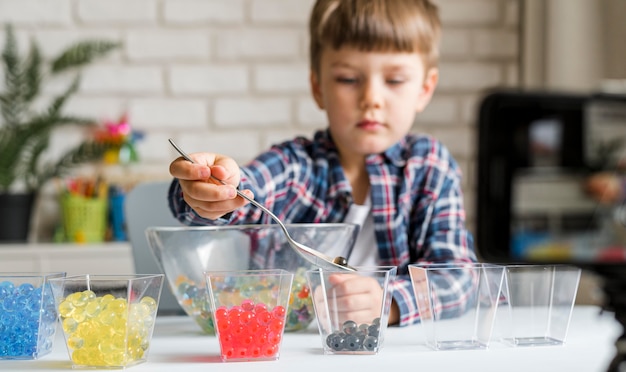 Little kid with hydrogel balls