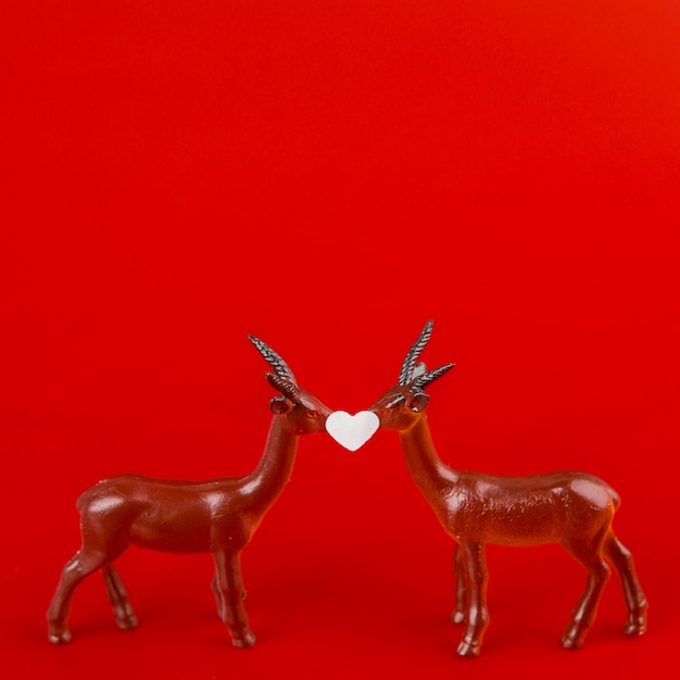 Free Photo little ornament heart between toy deer 