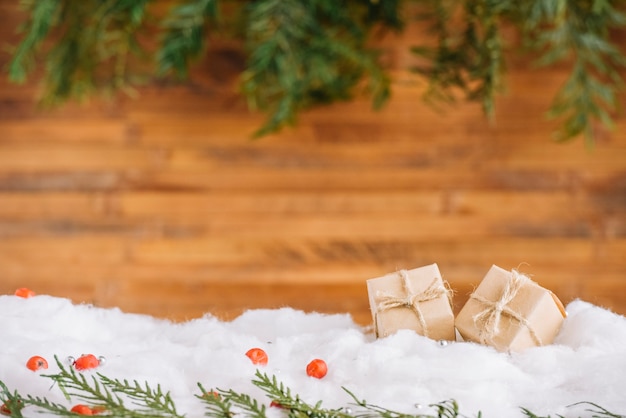 Little presents in snow with conifer branches