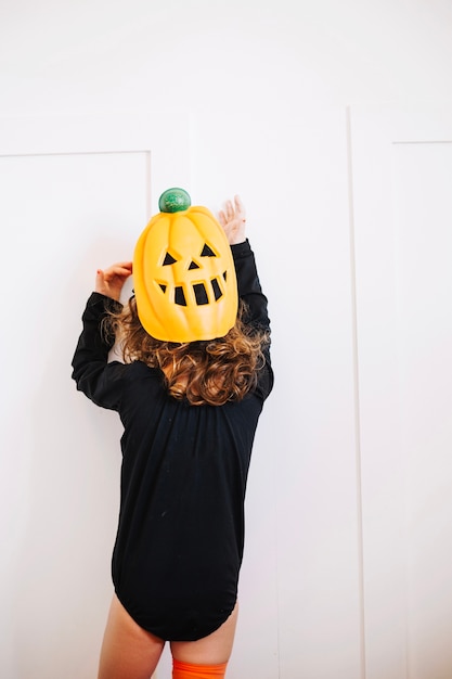 Free photo little pumpkin looking at white wall