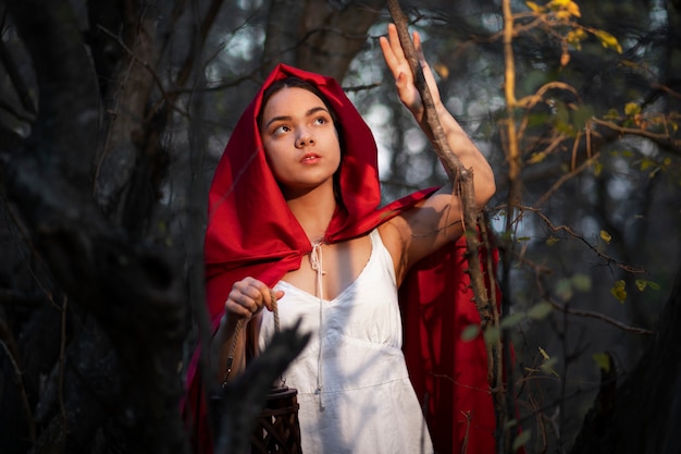 Free Photo little red riding hood in the forest portrait